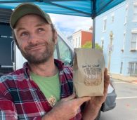 Kip Kelley of holding a bag of Full Cellar farm wheat