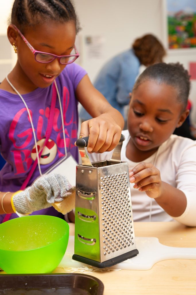 Kids grating with protective gloves