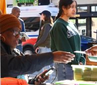 Shopper using the digital Produce Plus card at a farmers market