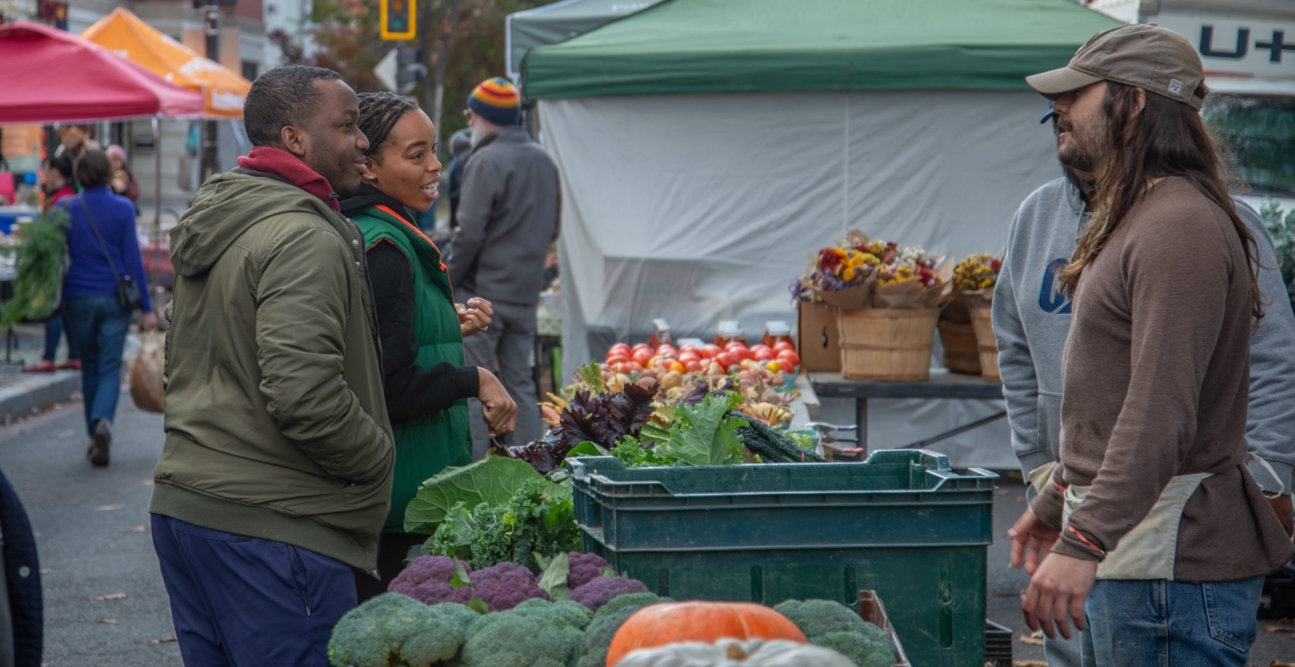 Shoppers talking for a farmer at the FRESHFARM H Street NE Market