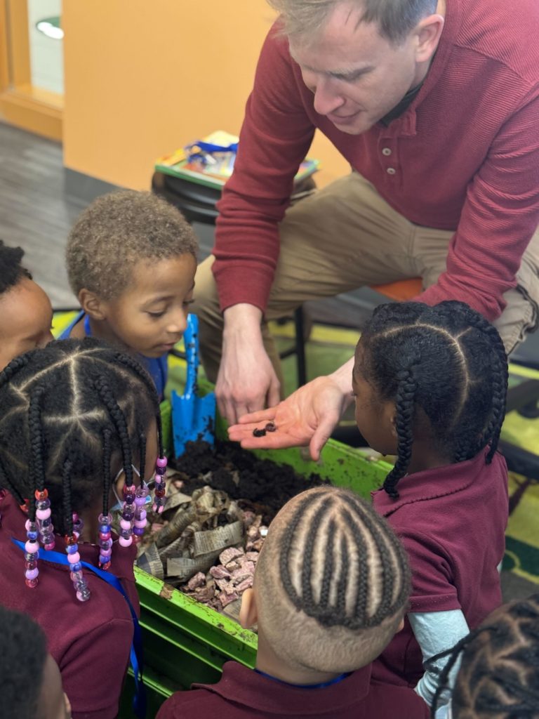 FoodPrints students checking out worms in compost STEM aligned food and garden education