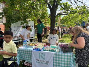 students table at a school Earth Day event