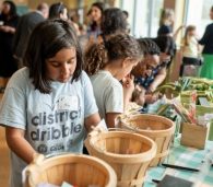 Students making seed packages at the FoodPrints 20th anniversary event. Photo by Cookie Captures