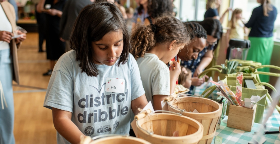 Students making seed packages at the FoodPrints 20th anniversary event. Photo by Cookie Captures