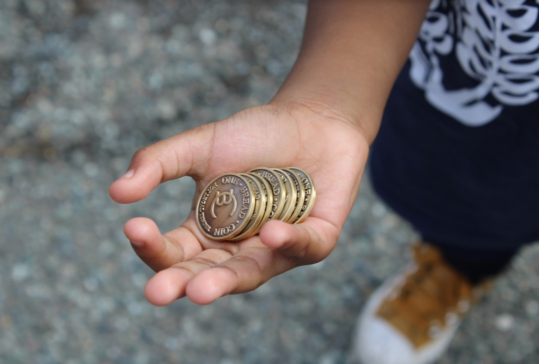 Hand holding Breadcoin tokens