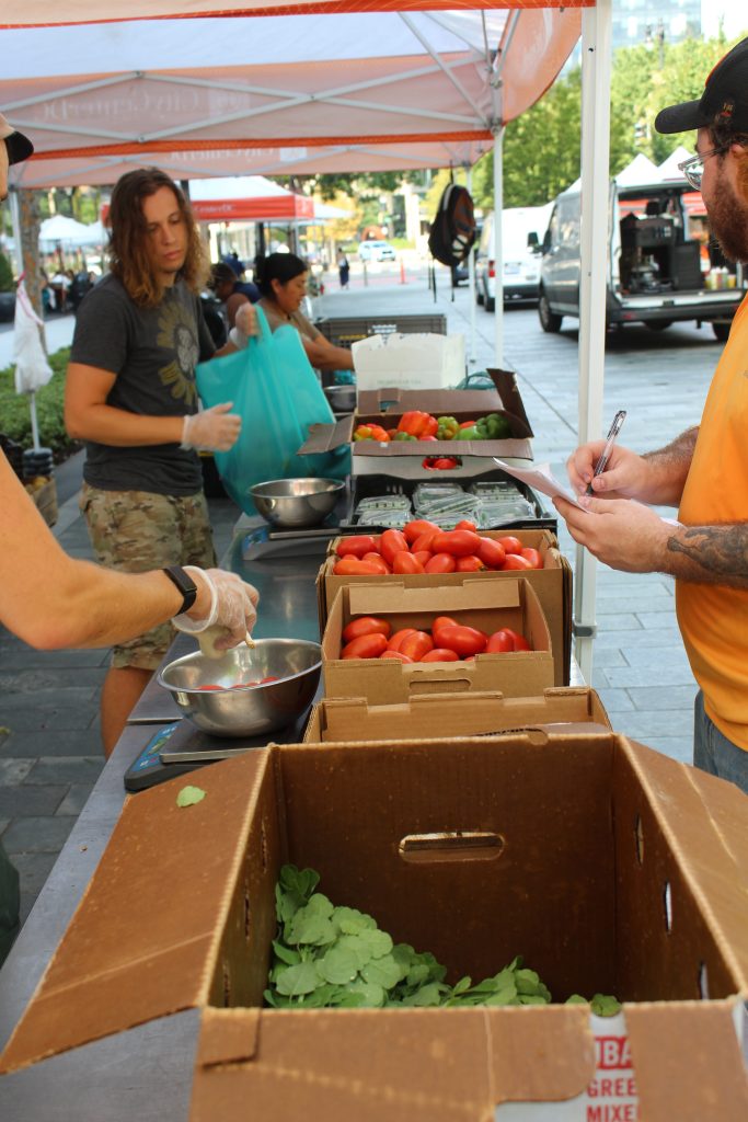 FRESHFARM Food Hub team members pack bags for distribution